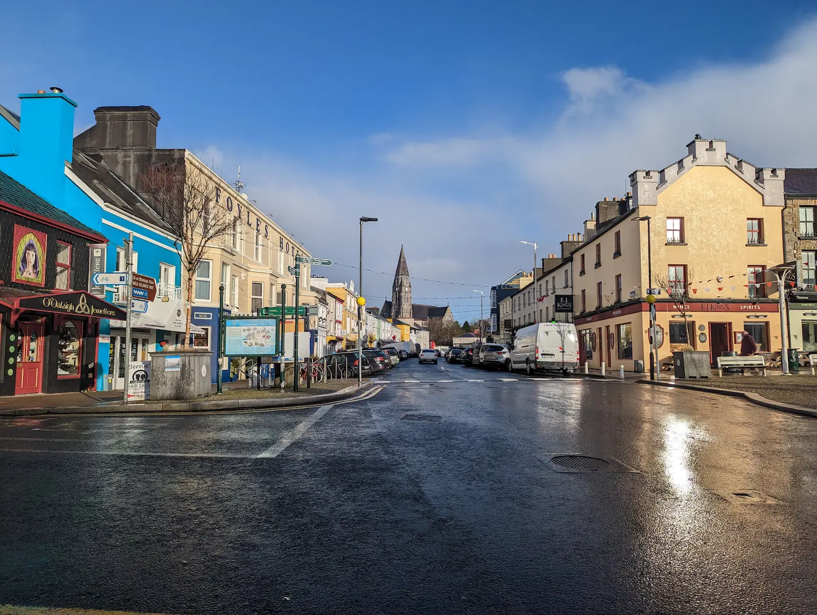 A wet street in Clifden Ireland with Foyle's Hotel and local businesses